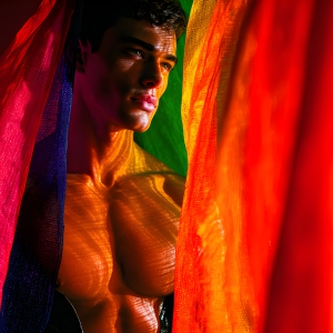 AI-generated art capturing men in a rainbow of colors creates a striking visual impact, blending surreal, vibrant, and high-fashion elements. Featuring artwork of beautiful, shirtless, muscular men embellished with or surrounded by a vibrant rainbow palette, evoking themes of pride, vitality, and artistic expression.
