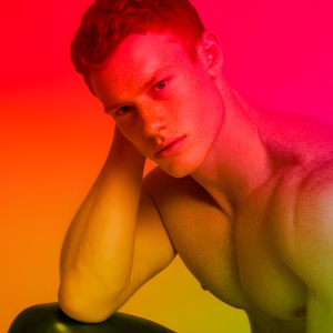 AI-generated art capturing men in a rainbow of colors creates a striking visual impact, blending surreal, vibrant, and high-fashion elements. Featuring artwork of beautiful, shirtless, muscular men embellished with or surrounded by a vibrant rainbow palette, evoking themes of pride, vitality, and artistic expression.