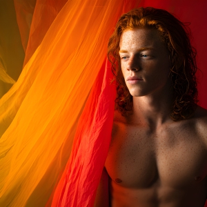 AI-generated art capturing men in a rainbow of colors creates a striking visual impact, blending surreal, vibrant, and high-fashion elements. Featuring artwork of beautiful, shirtless, muscular men embellished with or surrounded by a vibrant rainbow palette, evoking themes of pride, vitality, and artistic expression.