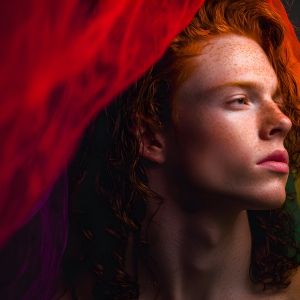 AI-generated art capturing men in a rainbow of colors creates a striking visual impact, blending surreal, vibrant, and high-fashion elements. Featuring artwork of beautiful, shirtless, muscular men embellished with or surrounded by a vibrant rainbow palette, evoking themes of pride, vitality, and artistic expression.