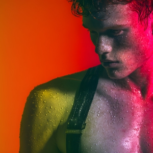 AI-generated art capturing men in a rainbow of colors creates a striking visual impact, blending surreal, vibrant, and high-fashion elements. Featuring artwork of beautiful, shirtless, muscular men embellished with or surrounded by a vibrant rainbow palette, evoking themes of pride, vitality, and artistic expression.