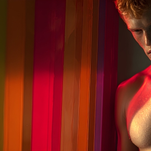 AI-generated art capturing men in a rainbow of colors creates a striking visual impact, blending surreal, vibrant, and high-fashion elements. Featuring artwork of beautiful, shirtless, muscular men embellished with or surrounded by a vibrant rainbow palette, evoking themes of pride, vitality, and artistic expression.