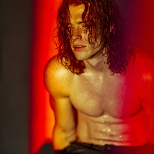 AI-generated art capturing men in a rainbow of colors creates a striking visual impact, blending surreal, vibrant, and high-fashion elements. Featuring artwork of beautiful, shirtless, muscular men embellished with or surrounded by a vibrant rainbow palette, evoking themes of pride, vitality, and artistic expression.