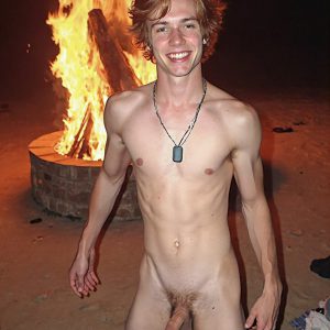 Bad Boys Naked Beach Party II. A full-body composition of a nude young man standing near a crackling bonfire, on a serene moonlit night at the beach. The gentle glow of the flames, flickers across his shinny wet body, catching his contours, and highlighting his muscular physique and handsome face. People everywhere partying, dancing to the music, having a good time together, naked, and free.